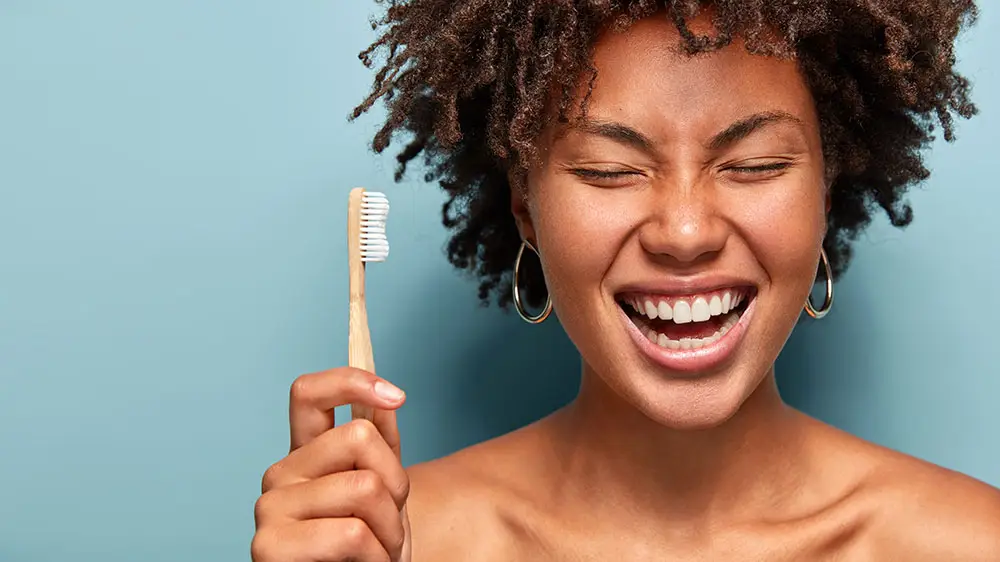 Lady smiling with toothbrush